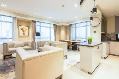 a large living room with couches and a kitchen at Marina Crown 2 BDR, Marina in Dubai