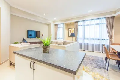 a kitchen and living room with a table and a couch at Marina Crown 2 BDR, Marina in Dubai