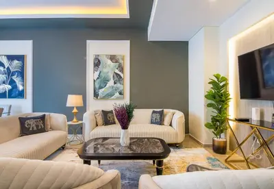 a living room with two couches and a table at Reem 3 BDR Villa in Dubai