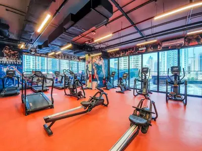 a gym with treadmills and elliptical machines at MBL Residence 2 BDR, JLT in Dubai