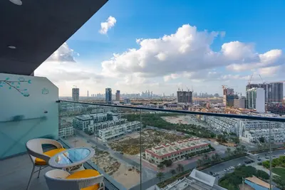 a view of a city from the balcony of a building at Bloom Heights 1 BR, JVC in Dubai