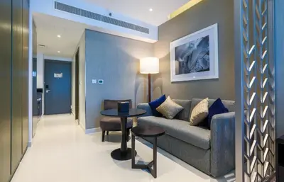 a living room with a couch and a table at Damac Maison Prive, Business Bay- Gorgeous Studio in Dubai