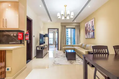 a living room with a couch and a table at Elite 1 BR, Downtown in Dubai