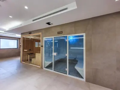 an empty room with a large glass door at Elite 1 BR, Downtown in Dubai