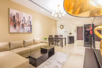 a living room with a couch and a table at Elite 1 BR, Downtown in Dubai