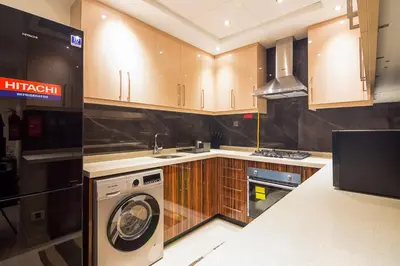 a kitchen with a washer and a washing machine at Elite 1 BR, Downtown in Dubai