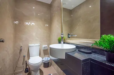 a bathroom with a white toilet and a sink at Elite 1 BR, Downtown in Dubai
