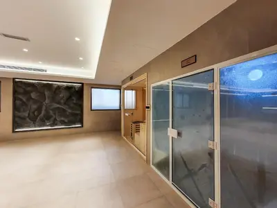 a room with a walk in shower and a glass door at Elite 1 BR, Downtown in Dubai