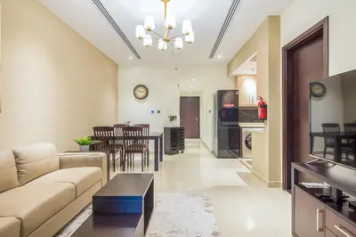 a living room with a couch and a table at Elite 1 BR, Downtown in Dubai
