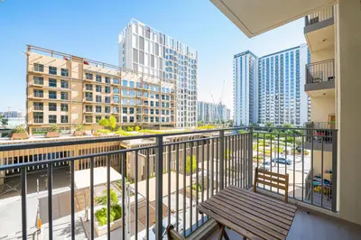 a balcony with a bench and some buildings at Park Heights 1 BR, Dubai Hills in Dubai