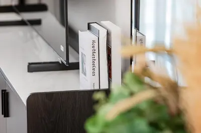 a row of books sitting on a desk at Premium Apartments at Executive Residences in Dubai