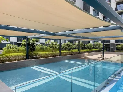 a swimming pool on the side of a building at Premium Apartments at Executive Residences in Dubai