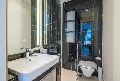 a bathroom with a sink and a toilet at Me Do Re1BR, JLT in Dubai