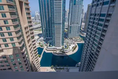 a view of a river between two tall buildings at Me Do Re1BR, JLT in Dubai