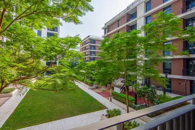 an apartment balcony with trees and a park at Park Point 1 BR, Dubai Hills in Dubai