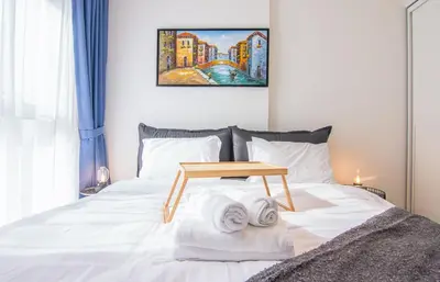 a bed with a wooden table on top of it at Collective 1,0 Dubai Hills- Cozy 1-BR in Dubai