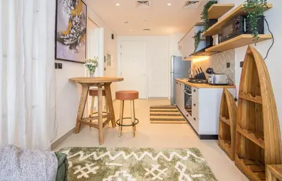 a kitchen with a counter and a table in a room at Collective 1,0 Dubai Hills- Cozy 1-BR in Dubai