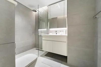 a bathroom with a toilet and a glass shower at StoneTree - Newly Furnished - Stylish in Dubai