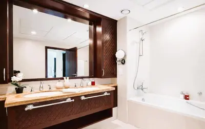 a bathroom with a sink and a tub and a mirror at Elite Royal Apartment - Sky Series - Full Burj Khalifa & Fountain View - Chancellor in Dubai