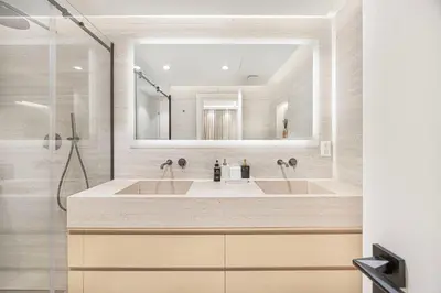 a bathroom with two sinks and a shower at Daniels Full Sea View 3BR in Oceana Atlantic in Dubai