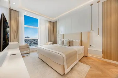 a bedroom with a large bed and a large window at Daniels Full Sea View 3BR in Oceana Atlantic in Dubai