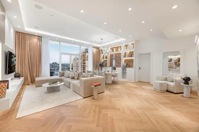 a living room with white furniture and wood floors at Daniels Full Sea View 3BR in Oceana Atlantic in Dubai