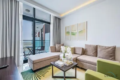 a living room with a couch and a table at Cosmopolitan 1BR Apartment in Celestia B, Dubai South by Deluxe Holiday Homes in Dubai