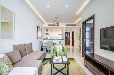 a living room with a couch and a table at Cosmopolitan 1BR Apartment in Celestia B, Dubai South by Deluxe Holiday Homes in Dubai