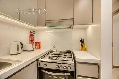 a kitchen with a stove top oven next to a sink at Creek Gate by Emaar, Dubai Creek Harbour in Dubai