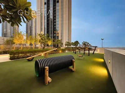 a playground in a city with a building at Creek Gate by Emaar, Dubai Creek Harbour in Dubai