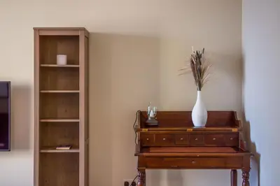 a table with a vase on top of it with a shelf at Two-Bedroom Apartment with Balcony in Shams 4, JBR in Dubai