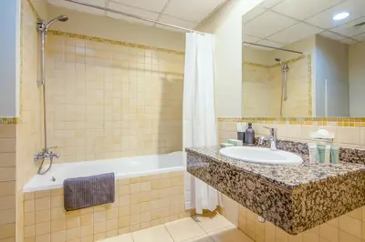 a bathroom with a sink and a tub at Two-Bedroom Apartment with Balcony in Shams 4, JBR in Dubai