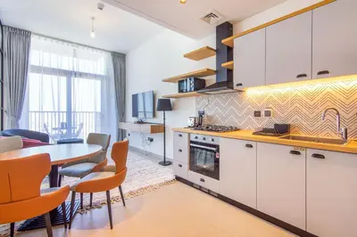 a kitchen with a table and a dining room at Collective 2,0 Dubai Hills- Attractive 1-BR in Dubai