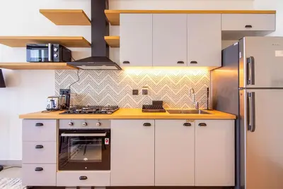 a kitchen with white cabinets and a refrigerator at Collective 2,0 Dubai Hills- Attractive 1-BR in Dubai
