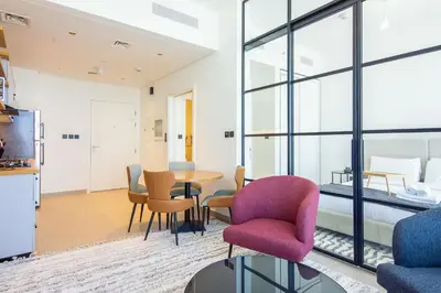 a living room with a table and chairs at Collective 2,0 Dubai Hills- Attractive 1-BR in Dubai