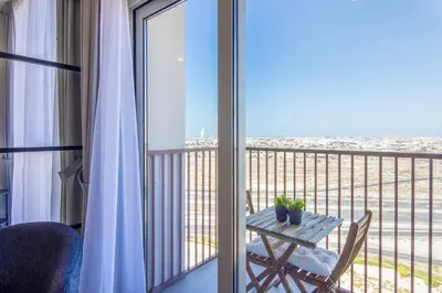 a balcony with a table and a view of the ocean at Collective 2,0 Dubai Hills- Attractive 1-BR in Dubai