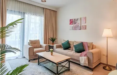 a living room with a couch and a table at Park Heights, Dubai Hills- Cozy 1-BR in Dubai