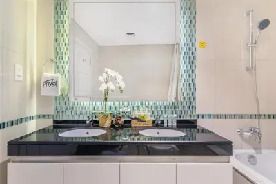 a bathroom with two sinks and a mirror at Prival - Marina & Sea View in Dubai