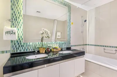 a bathroom with two sinks and a large mirror at Prival - Marina & Sea View in Dubai