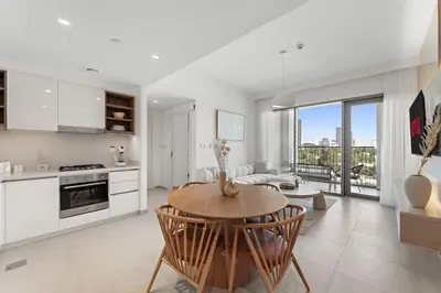 a kitchen and living room with a table at Chic 1BR Retreat - Near Burj Khalifa & Dubai Mall in Dubai