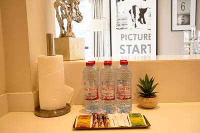three bottles of water sitting on top of a table at Luxurious 2BDR Apartment in Paramount Towers with Burj Khalifa Views in Dubai