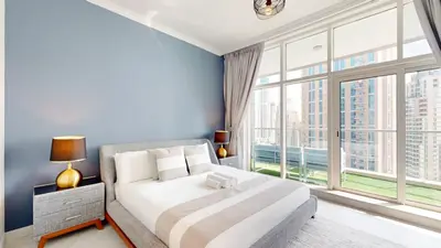 a bedroom with a large bed and a large window at Marinascape Oceanic - Luxurious Two Bedroom in Dubai