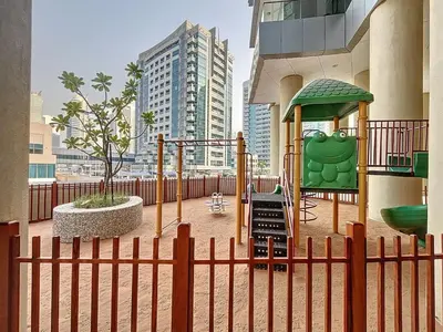 a playground in a building with a fence at Marinascape Oceanic - Luxurious Two Bedroom in Dubai