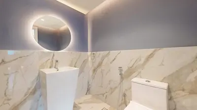 a bathroom with a white toilet and a mirror at Marinascape Oceanic - Luxurious Two Bedroom in Dubai