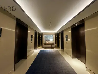 a hallway of a building with a carpet and a table at Luxurious 2BR The Address Opera in Dubai