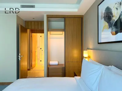 a bedroom with a bed and a picture on the wall at Luxurious 2BR The Address Opera in Dubai