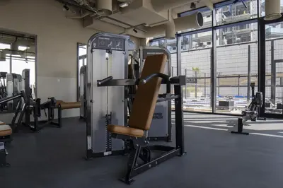a gym with a chair and a machine at Modern Studio at Upside Living, Business Bay with Burj Khalifa View in Dubai