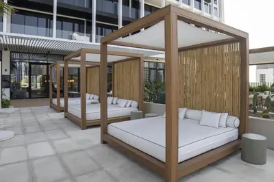 two beds on a patio in a building at Modern Studio at Upside Living, Business Bay with Burj Khalifa View in Dubai