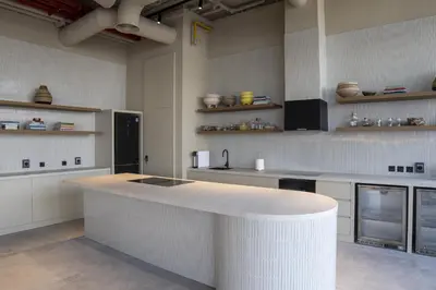 a kitchen with a large white counter in a room at Modern Studio at Upside Living, Business Bay with Burj Khalifa View in Dubai