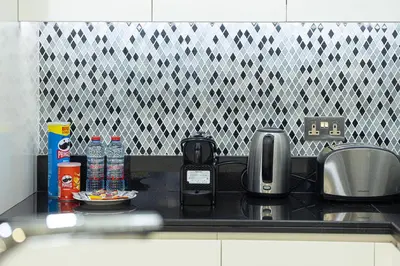 a kitchen counter top with a coffee maker and a toaster at Panoramic Burj Khalifa views-64th floor infinity pool in Dubai